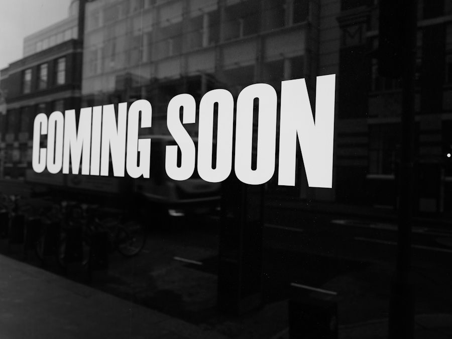 a black and white photo of a sign that says coming soon